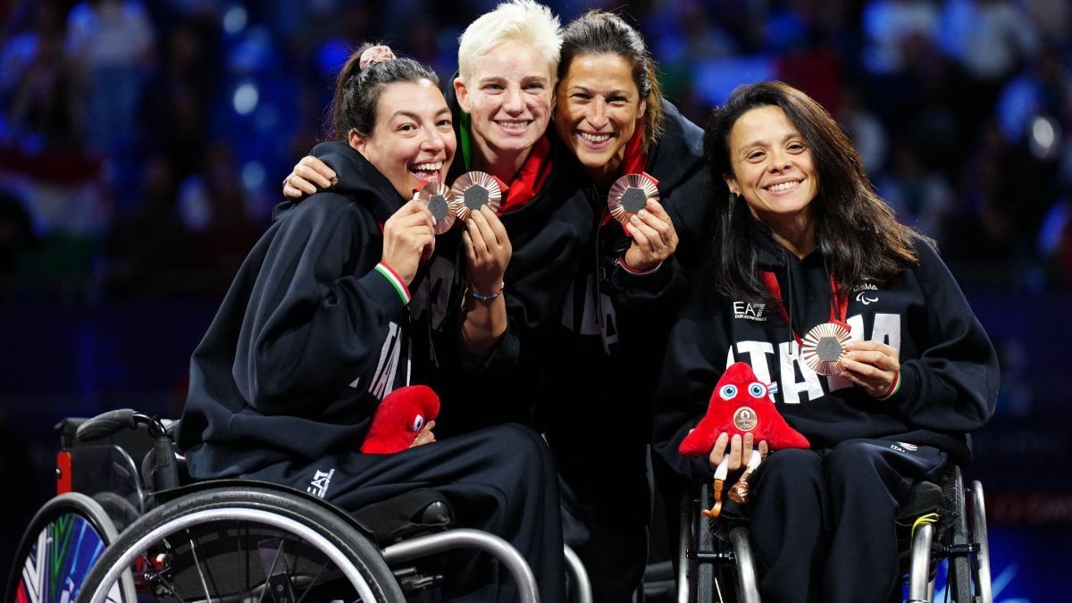 Fencers in wheelchairs Andreea Mogos, Bebe Vio, Loredana Trigilia and Rossana Pasquino pose on the podium. GETTY IMAGES