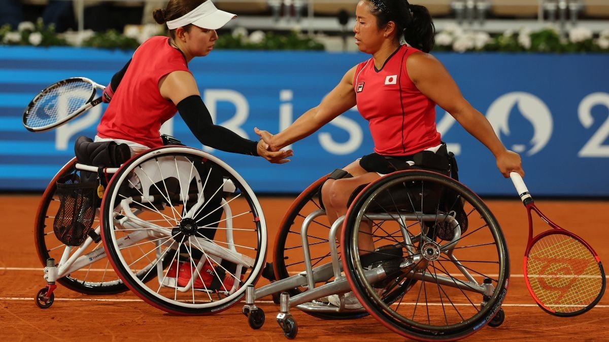 Yui Kamiji and Manami Tanaka celebrate a point in the Women's Doubles Gold Medal Match. GETTY IMAGES